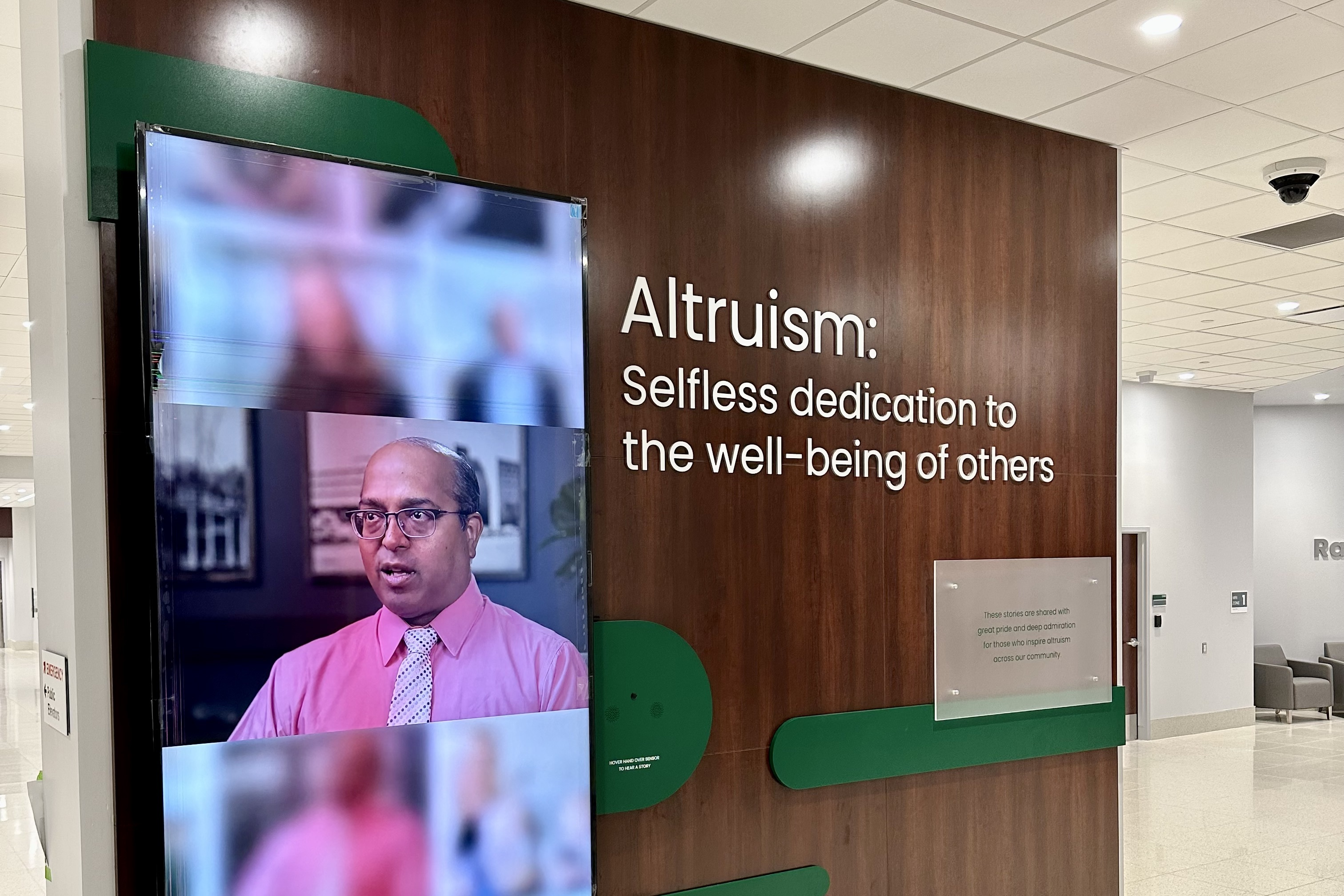 Large 100" video display shuffles through stories of patients, donors and staff